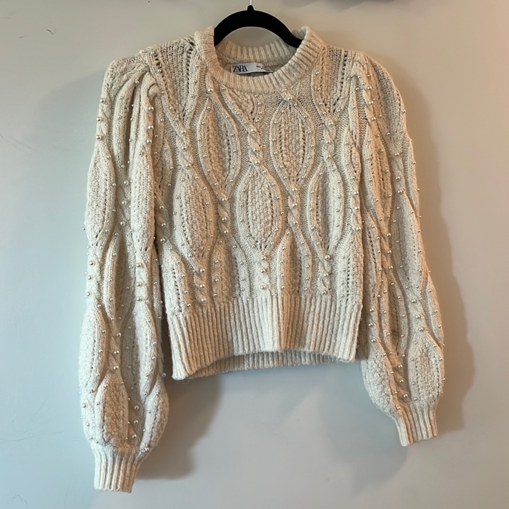 Wool, cashmere, poly blend short waisted sweater with pearl details.